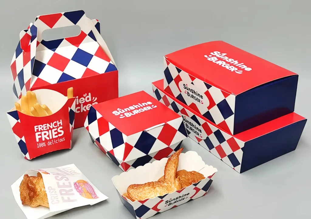 Burger, fries, and fried chicken served in custom paper boxes and bags.