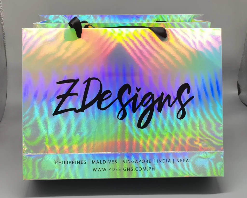 Holographic gift bag with iridescent rainbow finish, ideal for festive gifts.